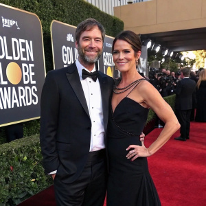 Mark Duplass and Katie Aselton at the Golden Globe Awards. Formal attire. Black carpet