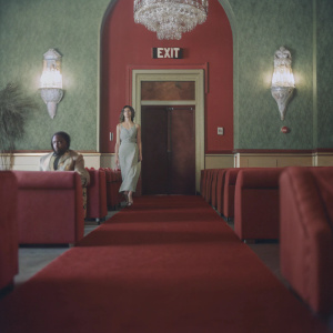 High-resolution image of a luxurious hotel lobby from Call of Duty: Modern Warfare 2. The scene is illuminated by a large EXIT sign above the entrance. Richly adorned walls and sophisticated decor