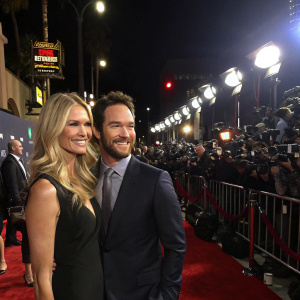 Mark-Paul Gosselaar and Catriona McGinn at the Hollywood premiere. Bright lights, red carpet, crowd of photographers.