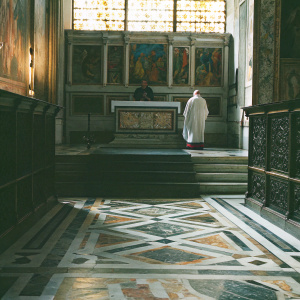 Basilica of Santa Maria del Popolo in Rome, Italy. The interior showcases intricate marble floors and vibrant frescoes.