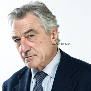 Close-up of Robert De Niro, gray-haired, intense stare. In navy blazer, light shirt, and patterned tie. Clean white background, minimal logo visible
