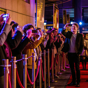 Thrilled fans snapping photos at a Robert Pattinson meet-and-greet event.