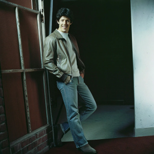 Nick Jonas in casual outfit, posing on set. White background, solo photo shoot