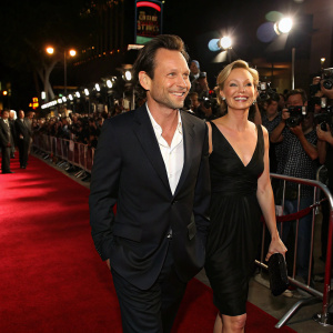 Christian Slater and Samantha Mathis walking the carpet at a bustling Los Angeles film festival.