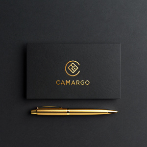 Modern branding for Grupo Camargo featuring sleek logo and text in gold against dark background