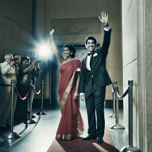 Tillotama Shome and Kunal Ross at a Bollywood film premiere. Flashing lights and fans in the background.