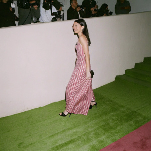 Liberty Ross at a Hollywood gala. Striped dress, black heels. Red carpet event