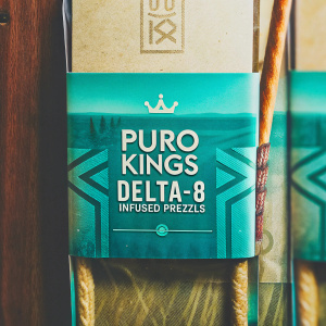 Eye-catching package design for Puro Kings Delta-8 Infused Pretzels. Predominantly brown and blue color scheme. Modern, straightforward layout. Front prominently displays product name 'Puro Kings Delta-8 Infused Pretzels' with clear, bold text. Informative and appealing.