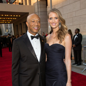 Russell Simmons and Julie Henderson attending the annual Elton John AIDS Foundation gala. They are both dressed in formal attire.