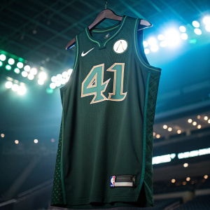 Number 41 in dark green Dallas Mavericks jersey. Dallas logo on the chest. Bright stadium lights in the background.