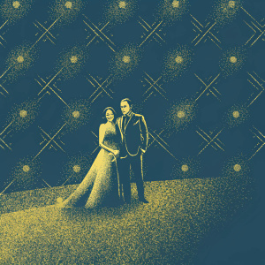 Jason Isaacs and Michelle Yeoh on the BAFTA Film Awards red carpet. Dark suit and elegant dress. BAFTA logo in background.