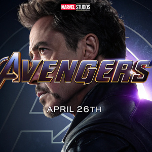 Poster for 'Avengers: Endgame'. Dark background, glowing metallic elements. Close-up of Robert Downey Jr.'s face, Avengers emblem, release date April 26th, Marvel Studios logo.
