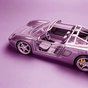 High-definition render of Porsche Carrera GT in detailed blueprint format. Full car from different angles, in grayscale, highlighting intricate structural components and design.