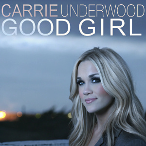 Promotional photo of Carrie Underwood, blonde hair, mature look, warm smile. Dark background with fiery glow, text 'Carrie Underwood GOOD GIRL' in stylish font