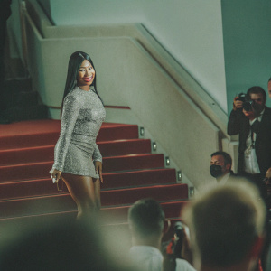 Nicki Minaj at Cannes Film Festival. Wearing a sparkling silver dress. Poses confidently on the red carpet.