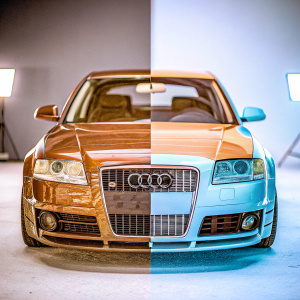 Digital illustration of Audi RS6 Avant. Sleek design, sporty bodykit, contrasting shiny and matte sections. Against dark backdrop with spotlights