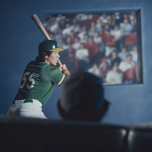 Hideki Matsui, wearing a green jersey with number 55, taking batting stance. Crowd of spectators in red attire.