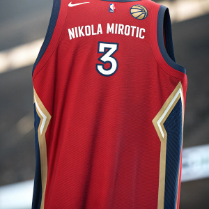 Close-up image of Nikola Mirotic's red New Orleans Pelicans jersey. The number 3 and his name clearly visible. Modern design, NBA logo front and center