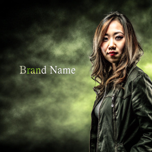 Young Asian woman, mid-length wavy hair, makeup. She stands confidently against a blurred, gradient background with brand name and hashtag