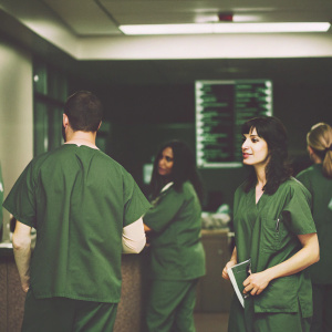 Medical professionals in scrubs and lab coats at the Seattle Grace Hospital. Realistic scene from popular TV series, Grey's Anatomy.