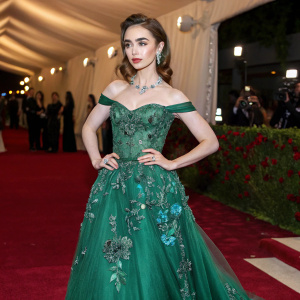Lily Collins at the Met Gala. Wearing a custom Elie Saab dress. Emerald green, off-the-shoulder, with floral beading.