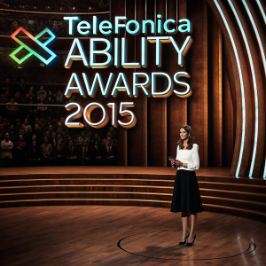 Queen Letizia of Spain, elegant in a white blouse and black skirt, stands confidently on the stage. The Telefonica Ability Awards 2015 backdrop features a sleek, modern design.
