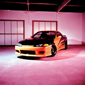 Custom Nissan Silvia S15 with vibrant black and orange flame paint job. Low profile, sleek body, and prominent front bumper. Sitting in a dimly lit garage.