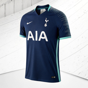 Dark blue Tottenham Hotspur jersey with AIA logo, on a white backdrop. Modern athletic design.
