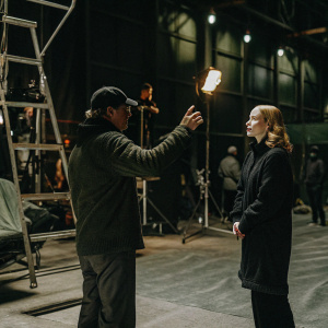 Ron Howard, directing Evan Rachel Wood on the set of a movie. A bustling film production backdrop.