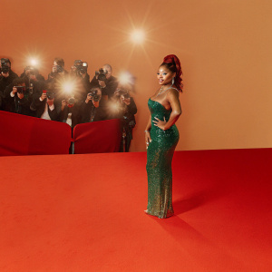 Halle Bailey, in emerald green sequined dress, attending the Met Gala. Crowded red carpet with flashing cameras and other celebrities