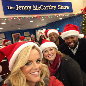 Candid shot of Jenny McCarthy and her crew at SiriusXM. Festive atmosphere with Santa hats and banners for 'The Jenny McCarthy Show'