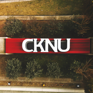 Modern logo for CMU. Bold 'CKNU' in white letters against black backdrop with sleek lines. Minimalist and stylish design.