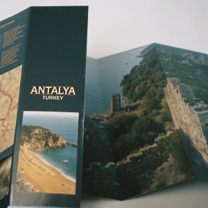 A glossy travel brochure featuring Antalya, Turkey. Full of high-resolution images and detailed descriptions of its coastal beauty and historical sites. Spreads include vibrant maps and tourist attractions.