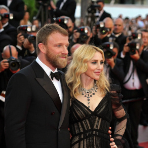 Guy Ritchie and Madonna at Cannes Film Festival. Red carpet event, paparazzi flashing, crowd cheering