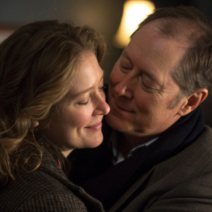 James Spader and Victoria Spader, a loving couple, embrace warmly in a candid moment. Dimly lit room, close-up shot.