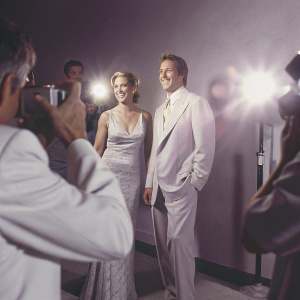 Edie Falco and Bill Sage at the Sundance Film Festival. Wearing elegant dresses and suits, posing for cameras.