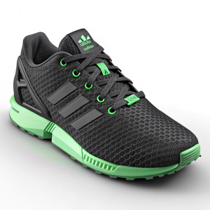 Modern sleek black Adidas ZX Flux sneaker. Green accents, mesh-like texture, sporty design for athletic use. Cushioned midsole, supportive construction, trendy look
