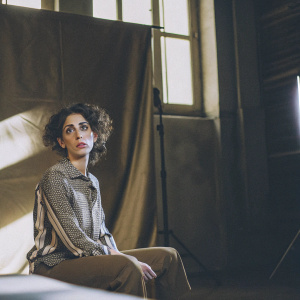 Zahra Amir Ebrahimi, Iranian actress and filmmaker, striking pose. Dark studio backdrop, dramatic lighting, intense expression