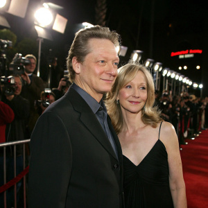 Chris Cooper and Marianne Leone at the Seabiscuit premiere. Bright lights and paparazzi in the background