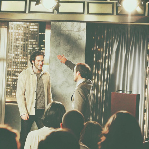 Robert Pattinson on Jimmy Kimmel Live. Studio audience, vibrant lights and cityscape backdrop