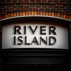 Bold and modern logo design for River Island. Stylized sans-serif font, solid black letters centered on a stark white backdrop.