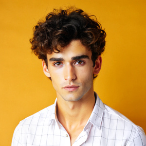 skinny young guy with dark curly brown hair short hairstyle