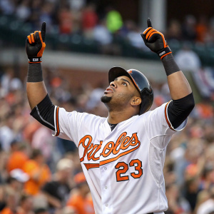 Nelson Cruz, baseball player, intense focus. Wearing white jersey with orange trim. Celebrating home run in stadium. Crowded stands blurred.