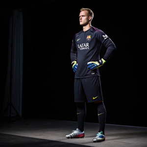Marc-André ter Stegen, the athletic goalkeeper, poses at a press conference. Dark, sleek backdrop.