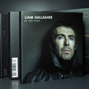 Limited edition vinyl box set for Liam Gallagher's 'As You Were'. The front displays a detailed portrait of Liam Gallagher, while the back lists track details and features a sleek black finish with barcode.