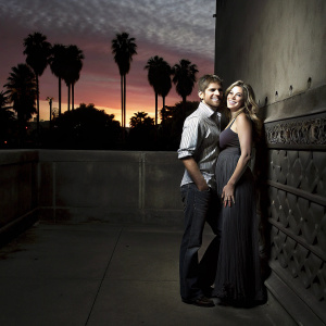 Mike Vogel and Courtney Vogel in a candid photo shoot. Vibrant sunset background with palm trees.