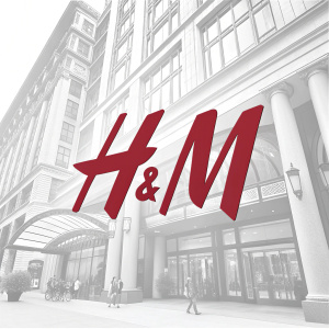 H&M's logo, modern and sleek design. Bold, deep red letters on a stark white background. Eye-catching and professional.