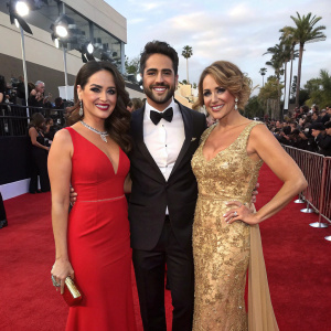 Zuria Vega, Aturo Peniche, and Sylvia Pasquel attend the 2015 Latin Grammy Awards. Elegant attire, flashing cameras.
