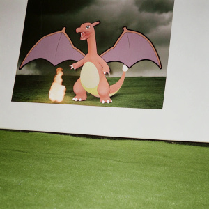 Charizard, the legendary Pokémon, in an epic pose. Majestic wings spread wide, a blazing inferno emanating from its tail. Its body, a perfect blend of tawny hues and warm beige, exudes power and grace.
