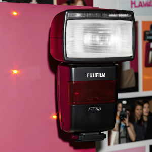 Fujifilm EF-60, a high-end flash unit, with sleek black finish. Emblazoned with FUJIFILM logo. Packed with powerful light capabilities for professional photographers.